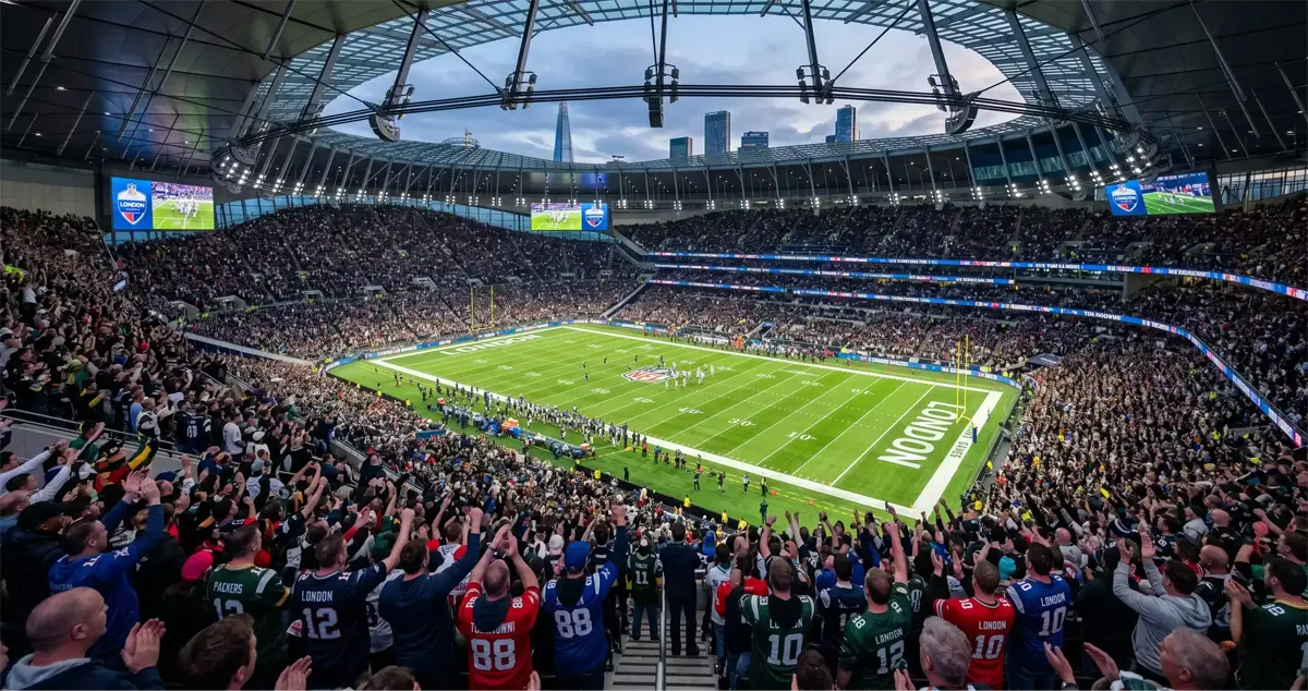 Crowd of UK fans cheering at an NFL London Game inside Tottenham Hotspur Stadium
