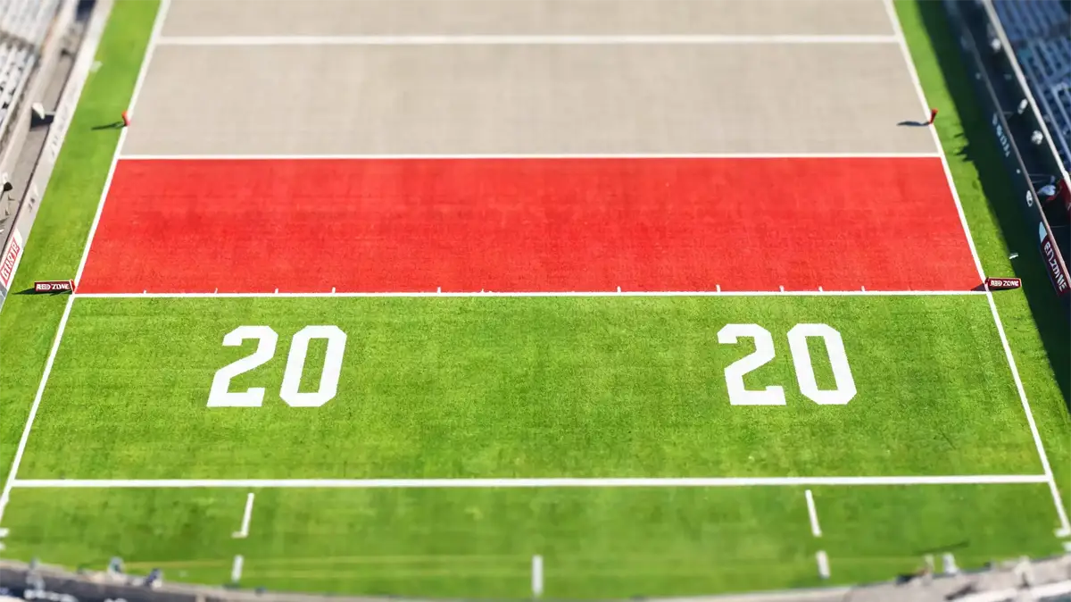 Overhead view of an NFL red zone with players lined up near the goal line
