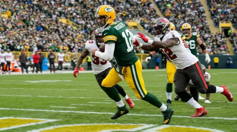 Mobile quarterback scrambling towards the end zone past defensive linemen