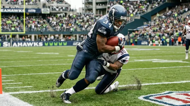 Running back carrying the ball towards the end zone with defensive players closing in