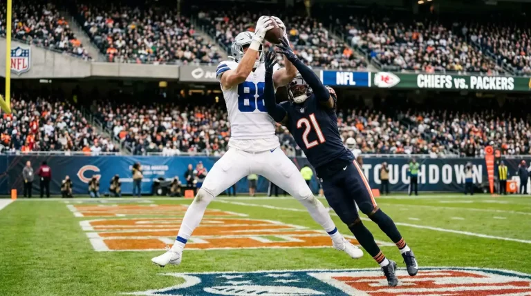 Wide receiver making a contested catch in the end zone during an NFL game